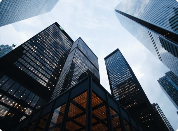 An upward view between city office buildings
